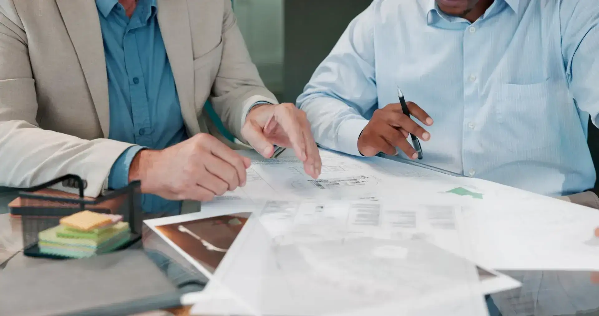 Two people reviewing loan documents at a desk